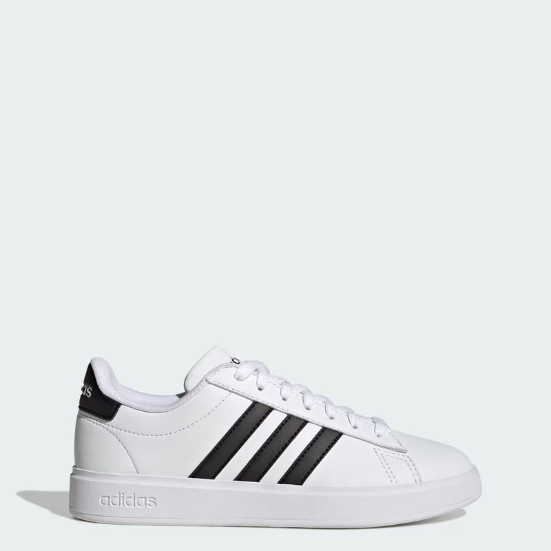 The adidas Grand Court 2.0 - Women sneaker features a Cloud White and Core Black design with Cloudfoam Comfort cushioning, white laces, and a white sole, displayed in side profile on a light gray background.